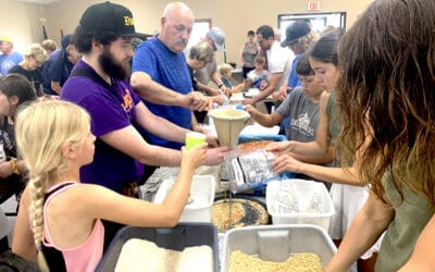 Serving others: Dozens of volunteers come together to bag 27,000 meals for Haiti
